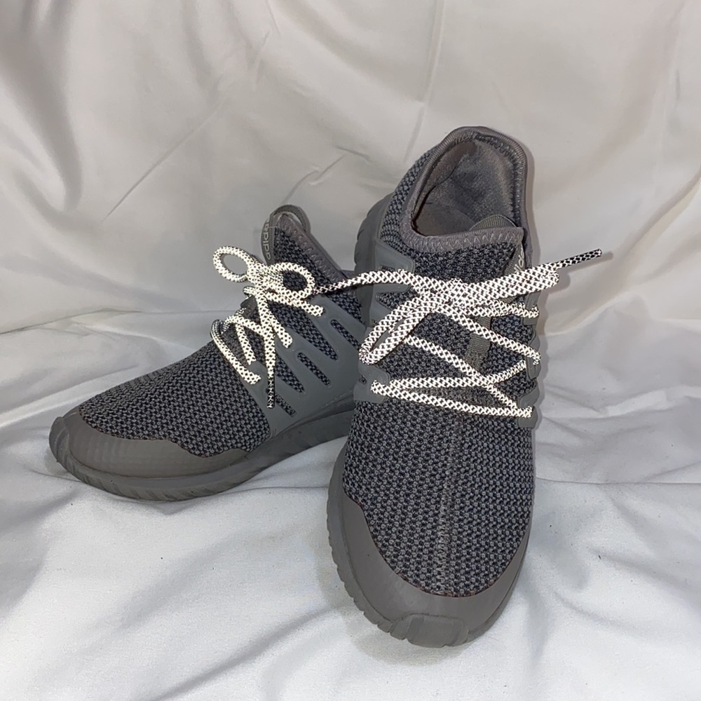 Grey adidas running sneakers with reflective shoelaces